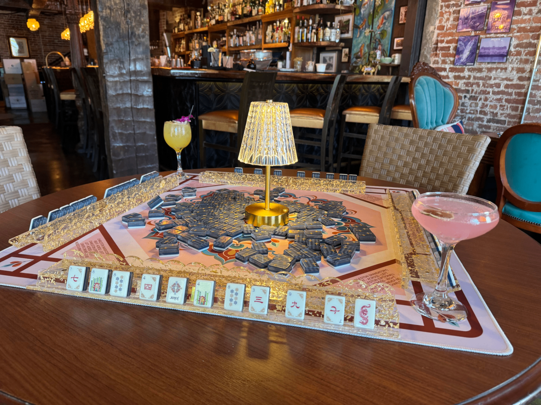 Charleston mahjong table set with cocktails at a downtown bar