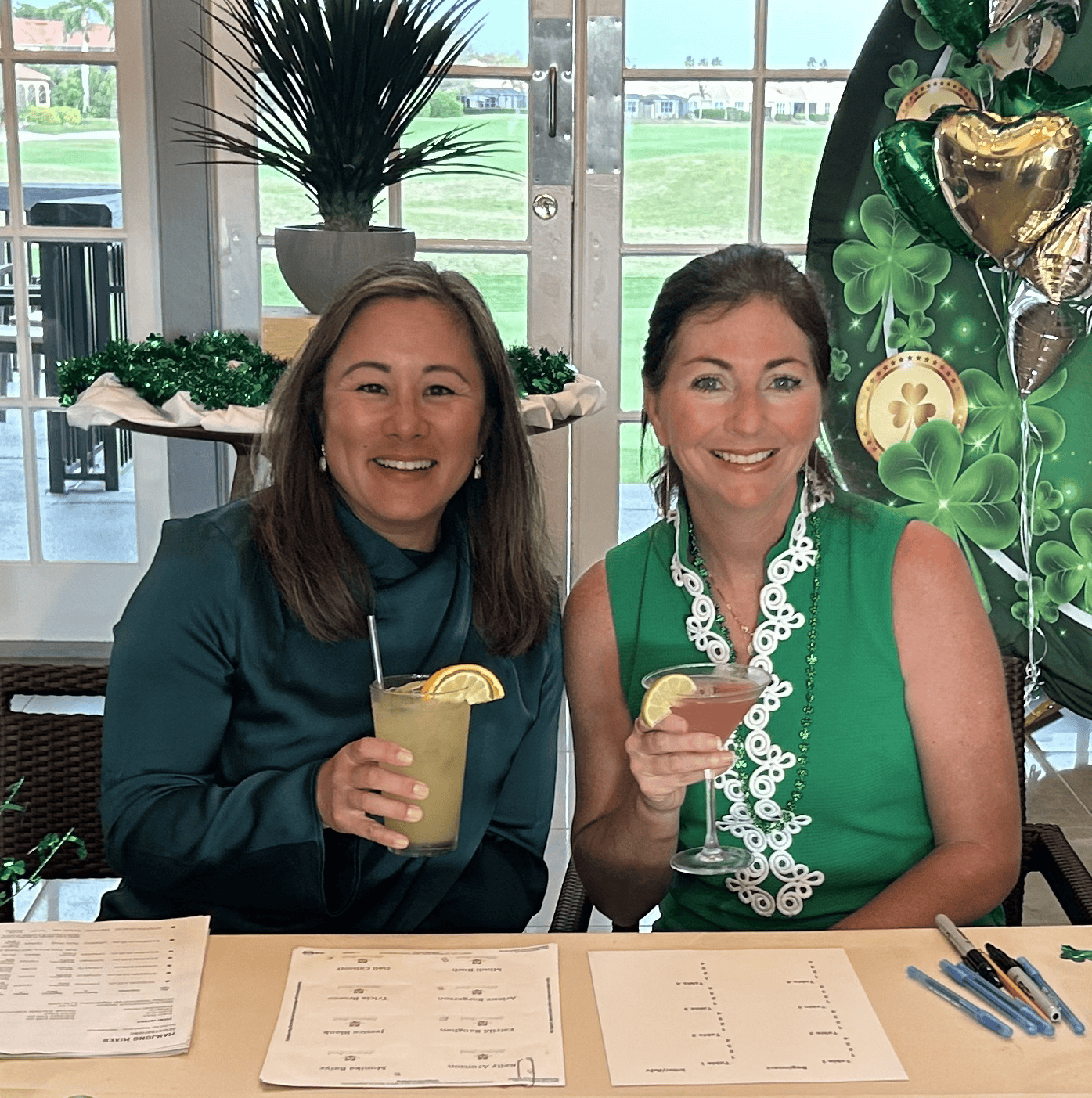 Two guests toasting cocktails at a St. Patrick's Day gathering