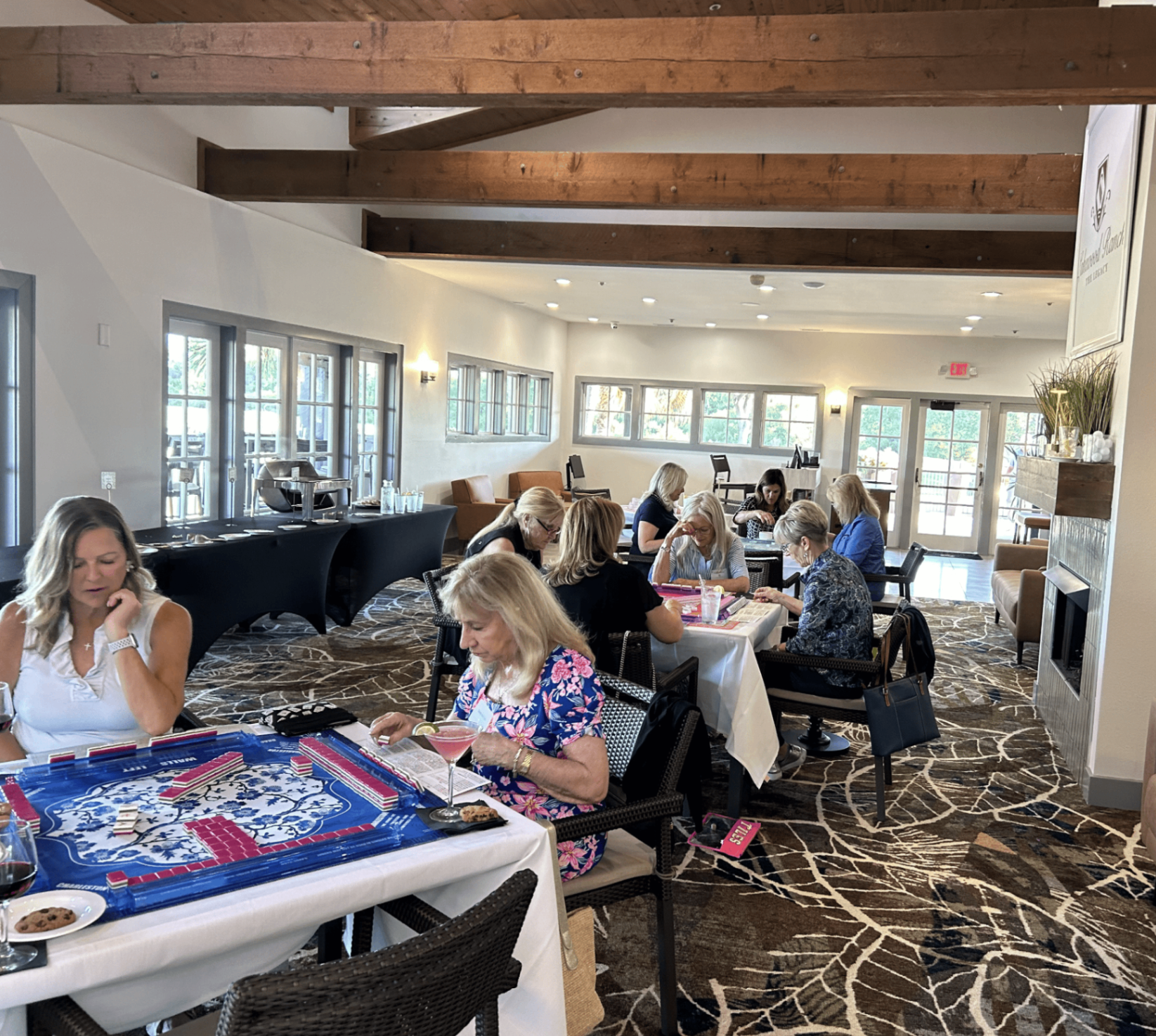 Guests playing mahjong in a beamed clubhouse room