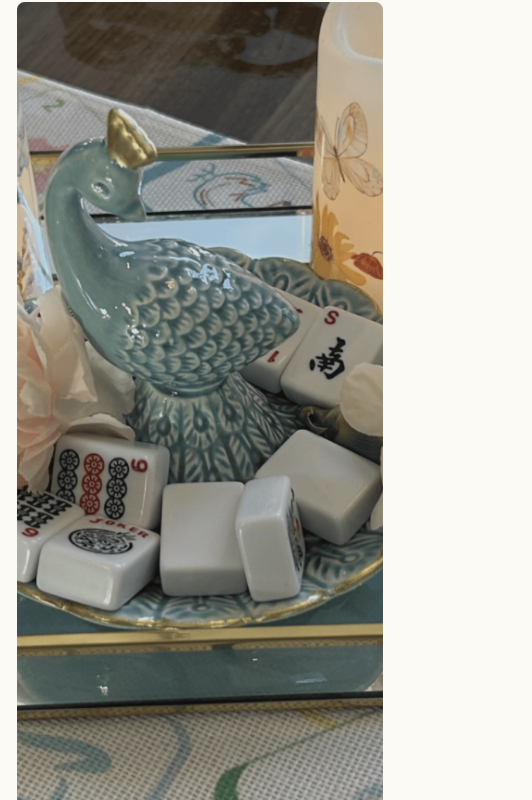 Porcelain peacock dish holding mahjong tiles